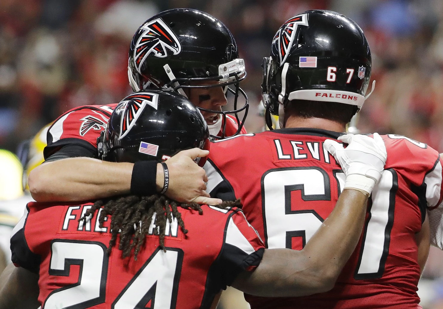 The Latest: Falcons’ Beasley hurts hamstring against Packers
